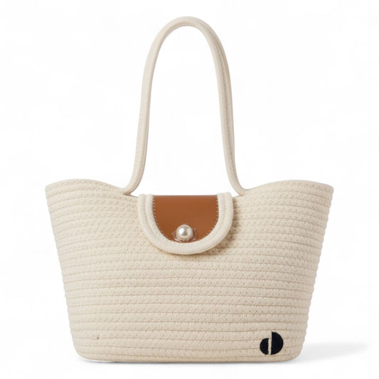 Beige woven tote with a brown flap and pearl embellishment on a white background